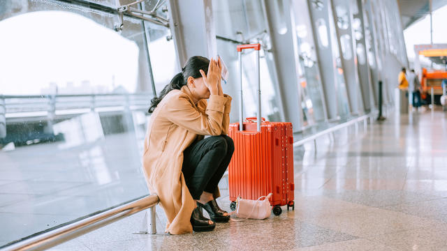 Young Asian woman upset and frustrated while flight canceled at the airport 