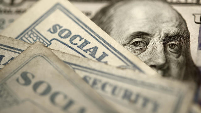 Social Security Cards On Top Of $100 Bill 