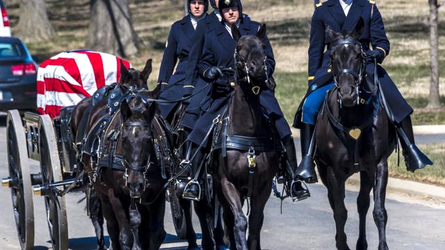 Burial at Arlington National Cemetery with coffin carried on horse drawn caisson 